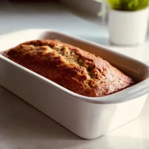 Deliciously moist banana bread loaf, freshly baked and sliced.