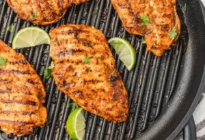 Delicious Mexican chicken marinated for grilling, showcasing vibrant spices and herbs.
