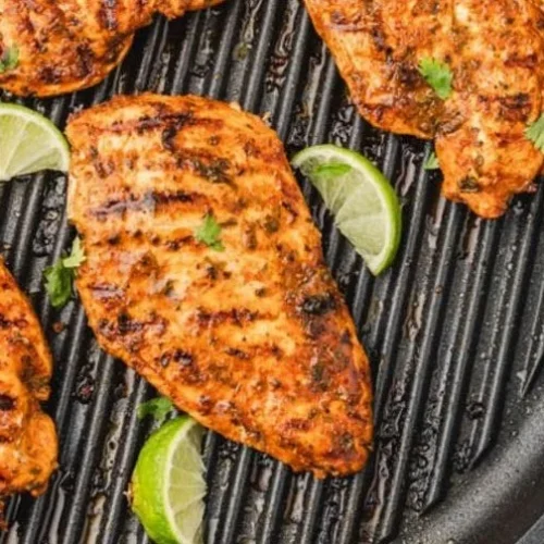 Delicious Mexican chicken marinated for grilling, showcasing vibrant spices and herbs.