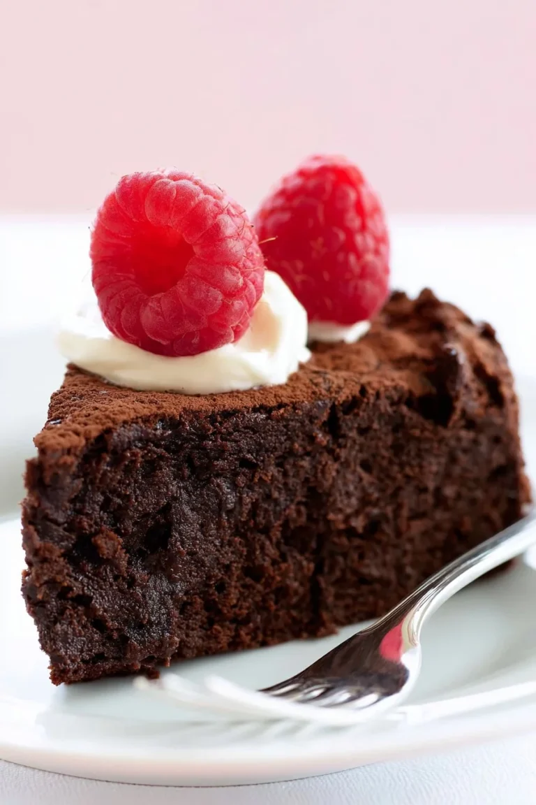 Delicious flourless chocolate cake ready to be served with a chocolate glaze.