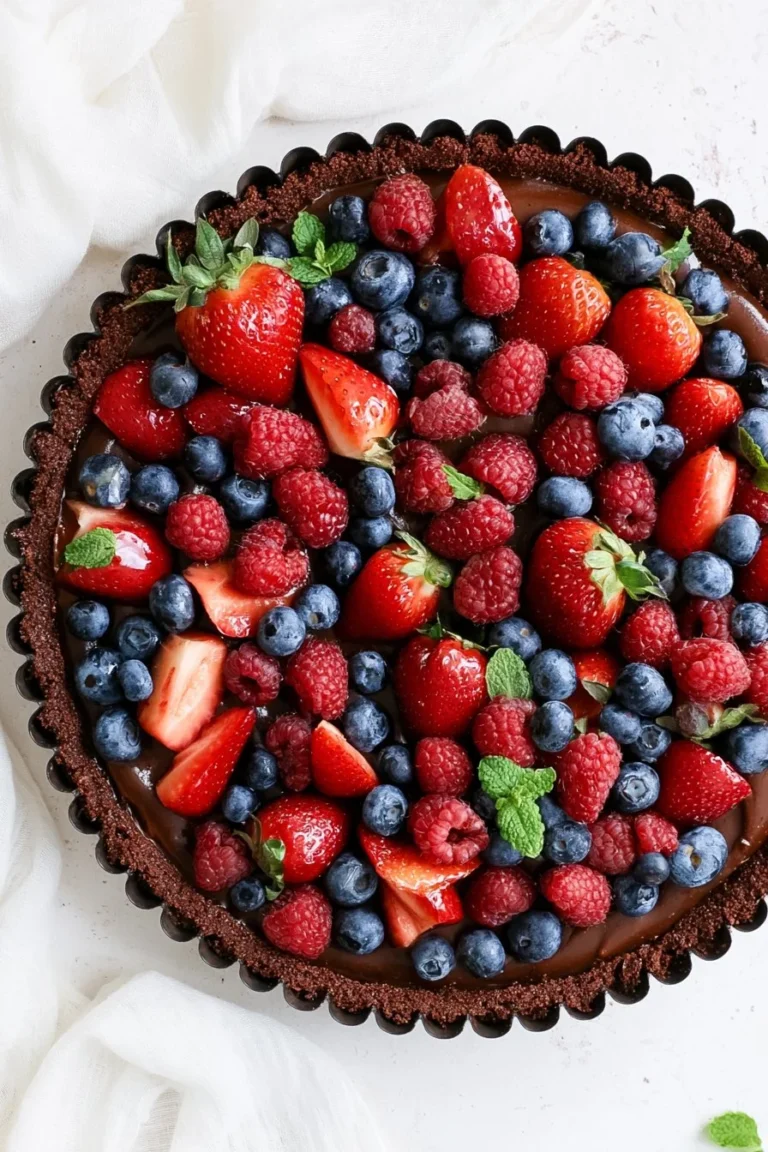 No Bake Chocolate Berry Tart topped with fresh berries, gluten-free and vegan.