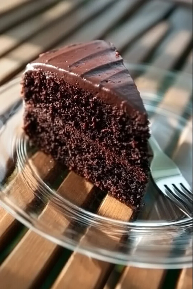 Ultra moist chocolate cake with rich frosting and chocolate garnishes.